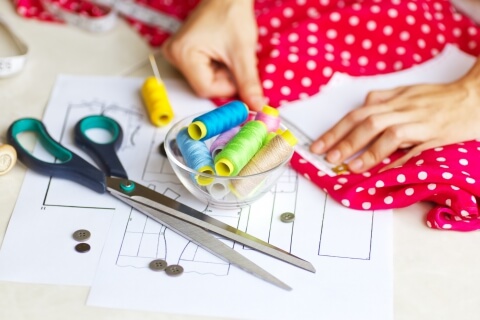 tailor-laying-out-dress-sewing-layout-soft-focus-45588737